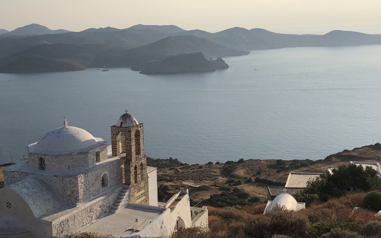 Stone church above Plaka, Milos, looking over the bay at sunset